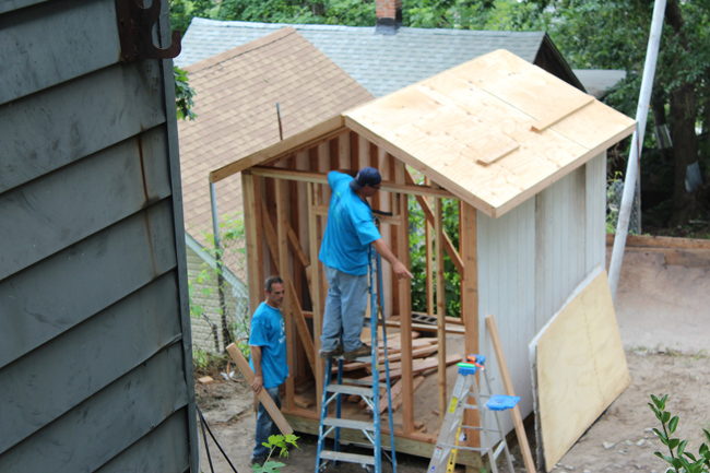 People working on building house