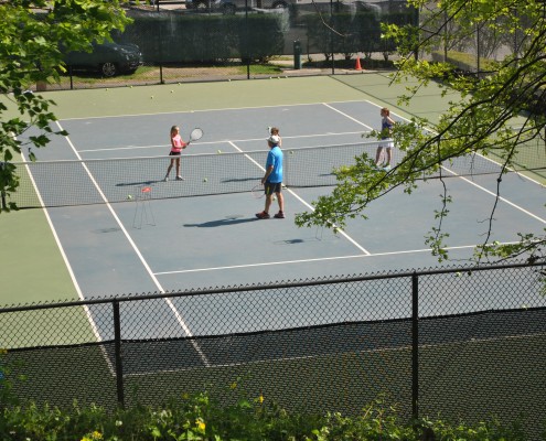 Three people playing Tennis in Bronxville