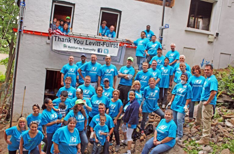 Group at Habitat for Humanity standing on rubble