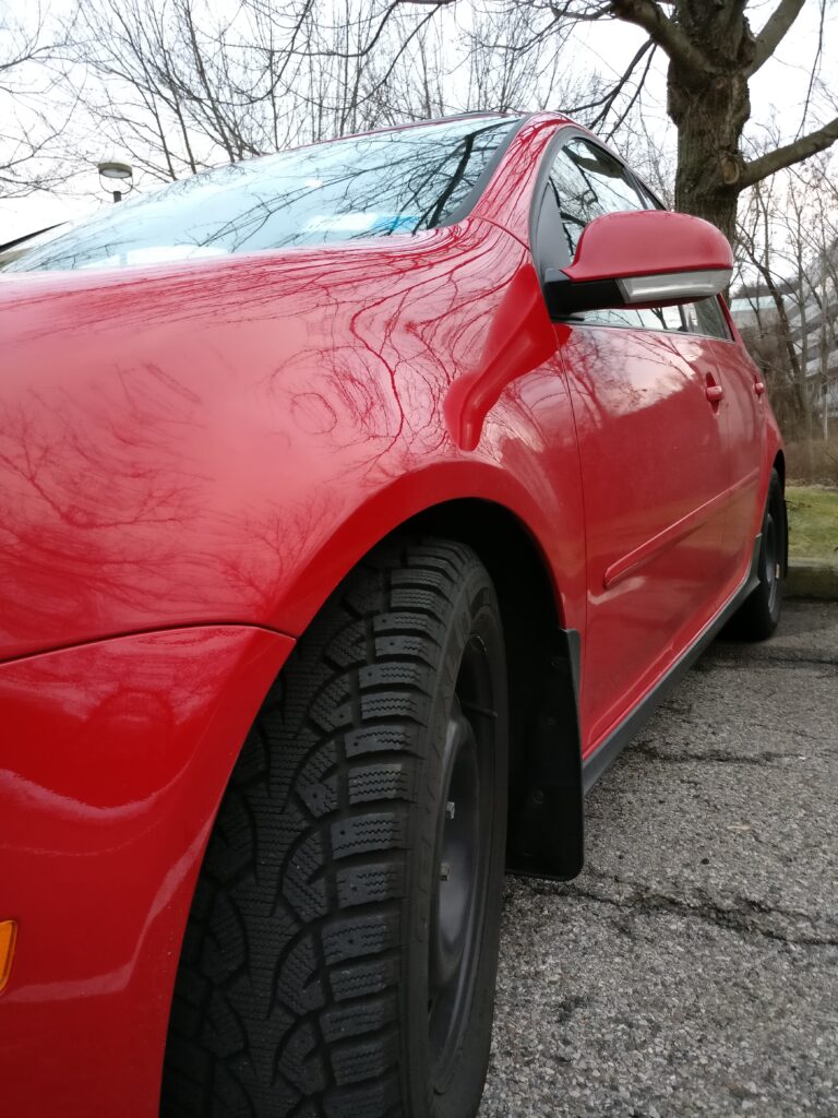 Snow tires on red car